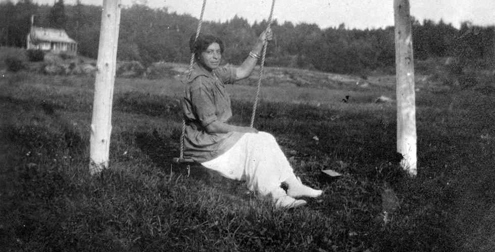 Violet on swing, Birch Dale Camp in background